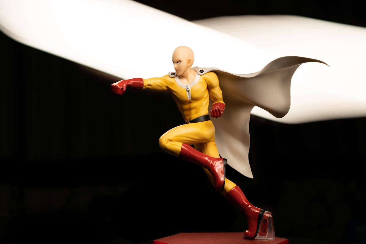 High-quality photo of a dynamic superhero action figure in a striking pose with a flowing cape.